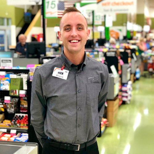 man standing near cash registers